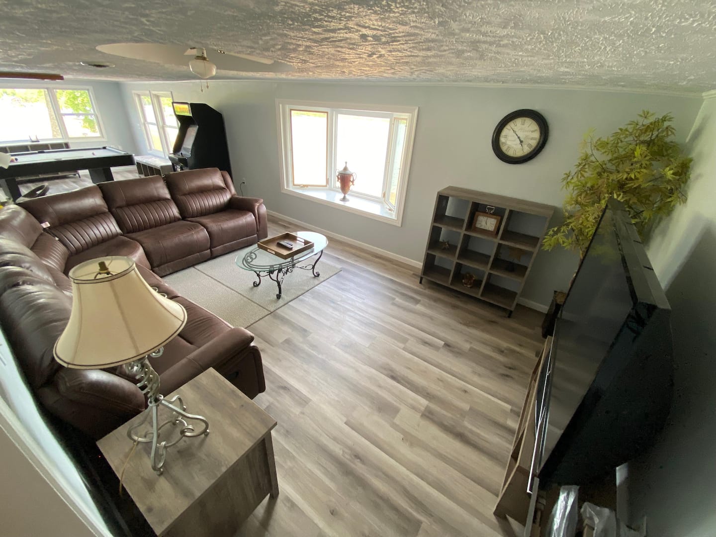 Living room with pool table, arcade games, and 60 inch TV